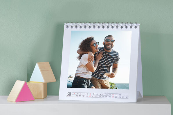 Square photo desk calendar with an image of a couple happy on holiday.