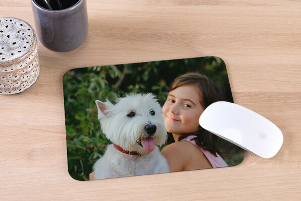 mouse mat printed with a photo of a girl and her dog on it.