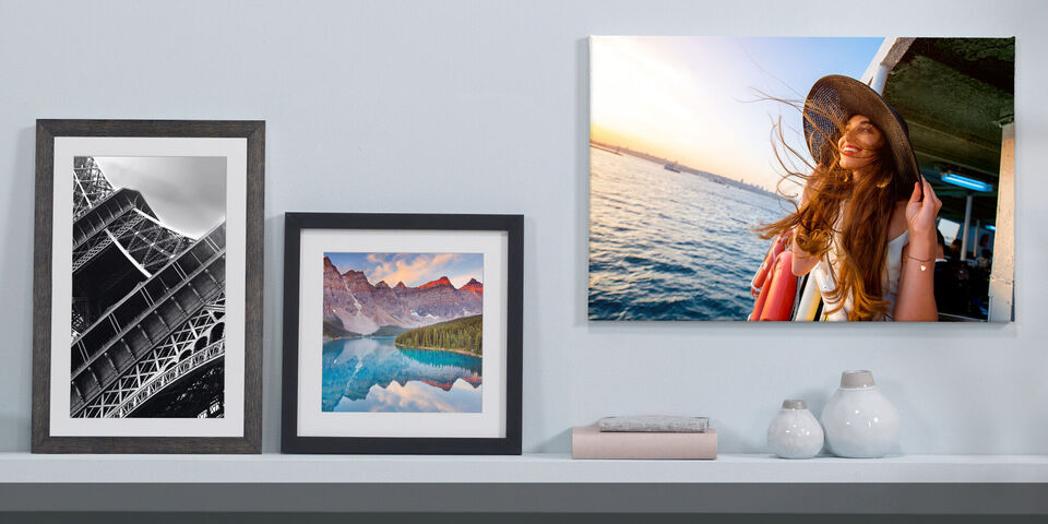 canvas print and framed poster prints on a wall and shelves